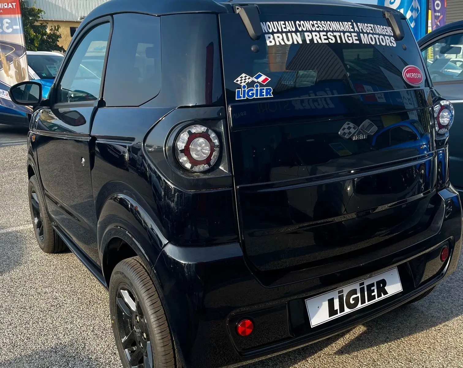 Vue intérieure côté conducteur de la LIGIER Myli I.DEL 8KWH 2024 noire, avec tableau de bord moderne et volant compact.