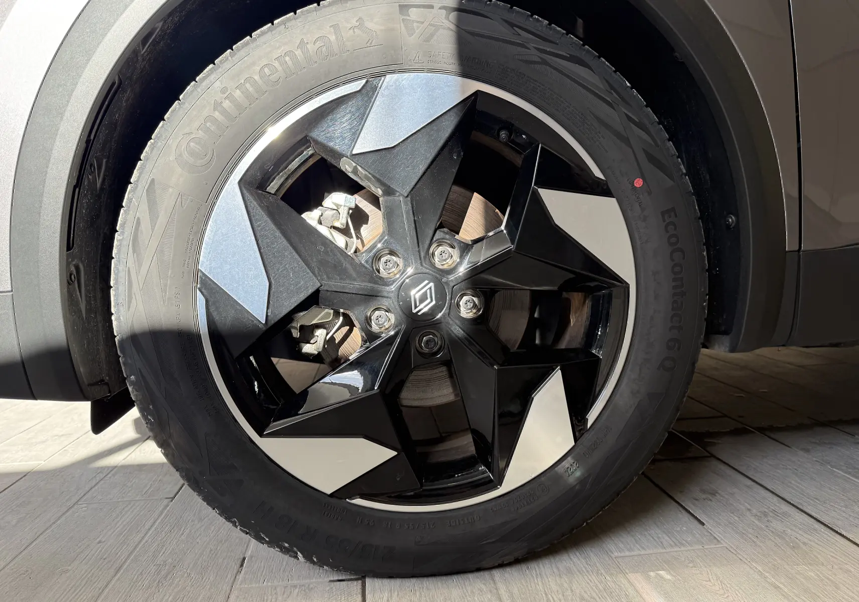 Gros plan sur la jante noire et argentée du côté gauche d’un Renault Captur gris Cassiopée Métal 2025 hybride.