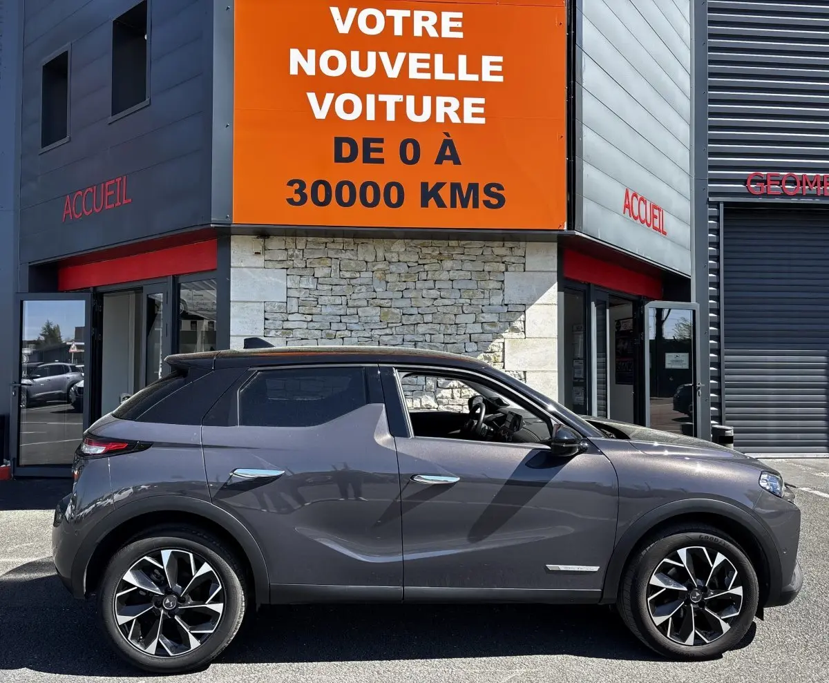 Vue latérale droite d'une DS3 1.2 PureTech 130 gris foncé, avec jantes alliage et toit noir contrasté.