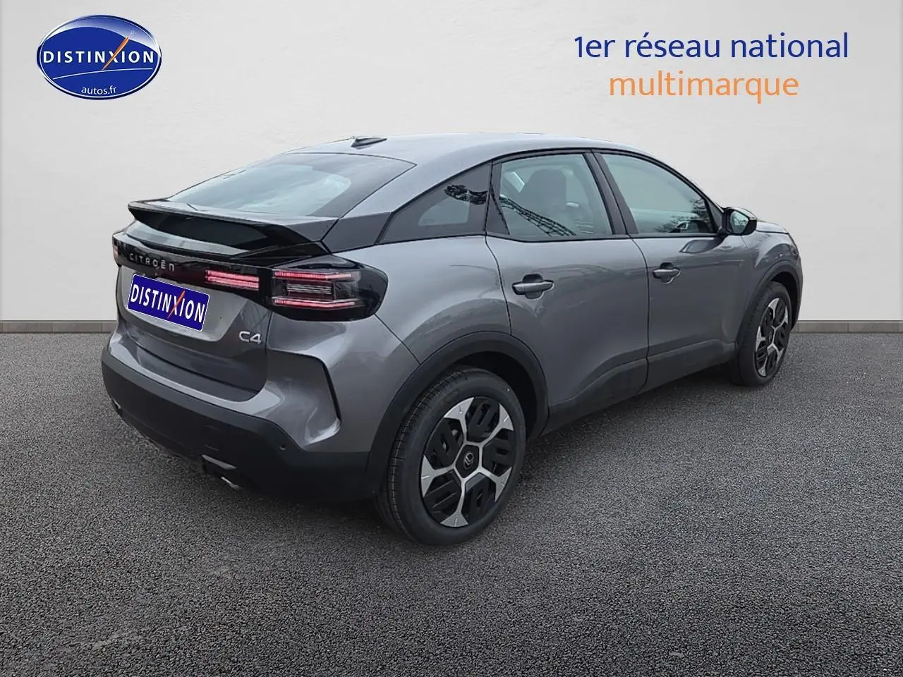 Vue 3/4 arrière droite d'une Citroën C4 gris mercury avec feux LED et jantes stylées sur sol gris.