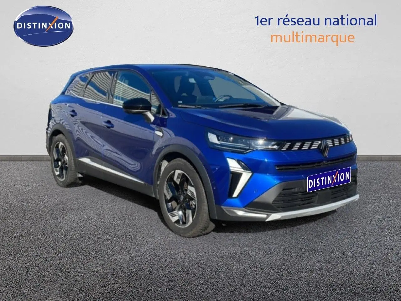 Renault Symbioz 2025 bleu Iron Metal en 3/4 avant droit, SUV hybride avec signature lumineuse LED distinctive.