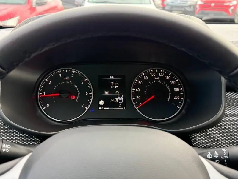 Vue intérieure centrée sur le tableau de bord et le volant du Dacia Sandero blanc Glacier 2025, version Essence.