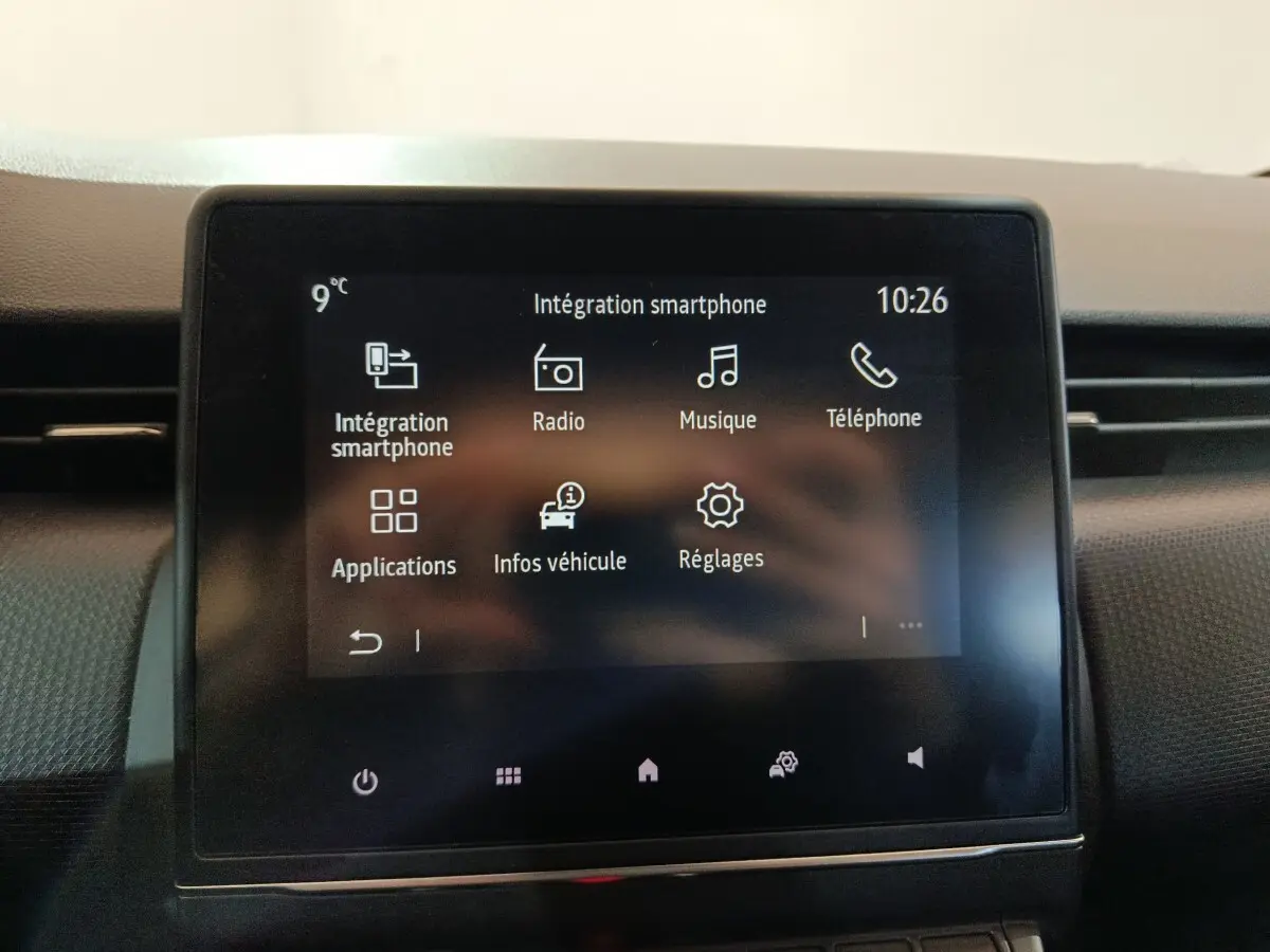 Écran tactile central de la Renault Clio gris clair 2023 affichant les options multimédias et réglages.