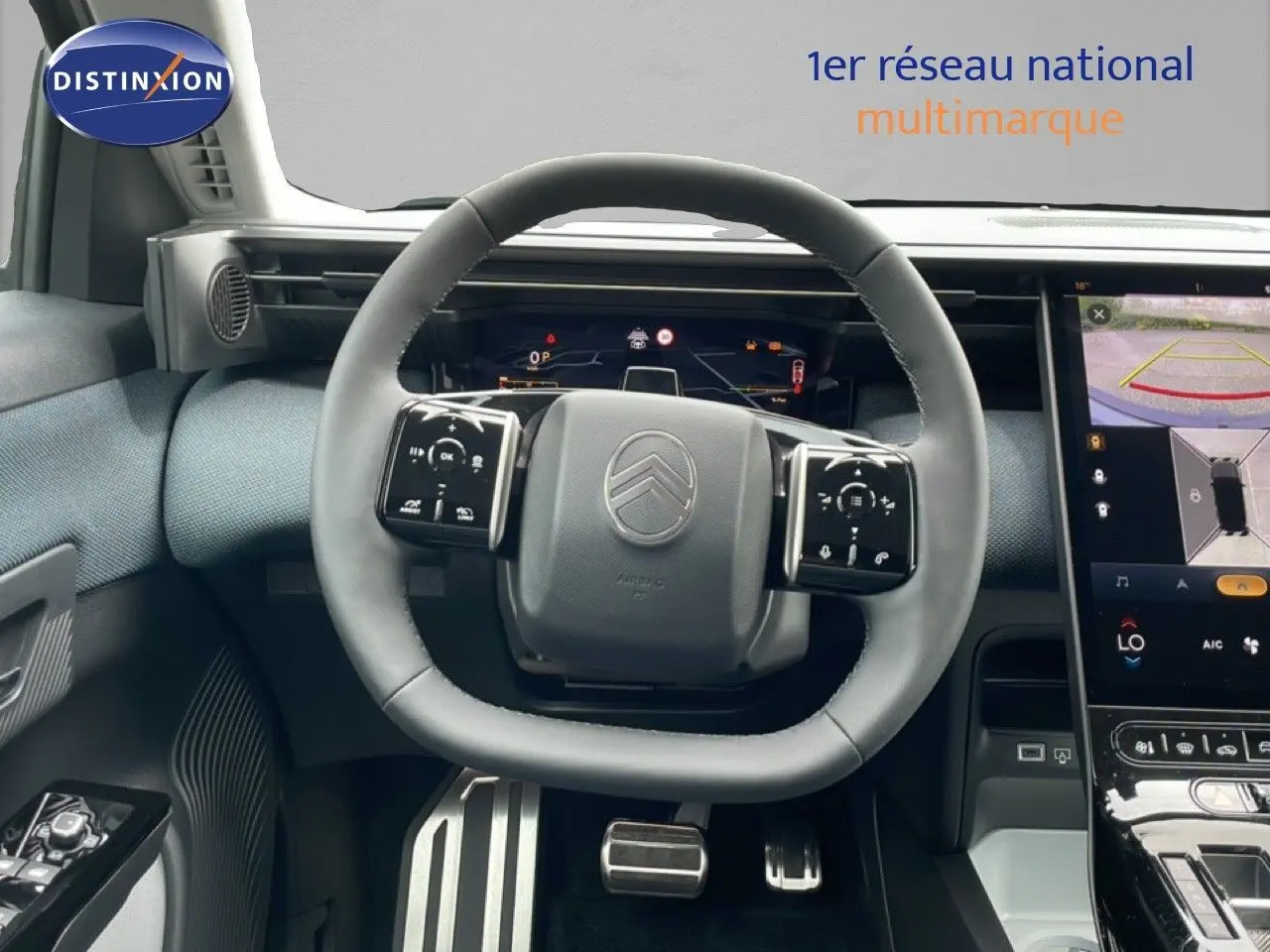 Vue intérieure centrée sur le volant du Citroën C5 Aircross 2026, avec tableau de bord numérique et écran tactile visible.
