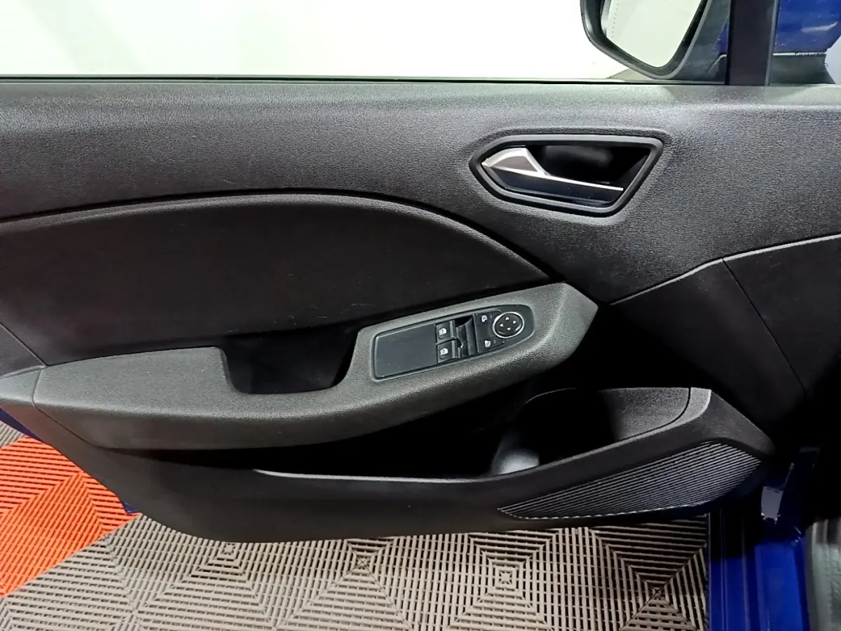 Vue rapprochée de la porte avant gauche noire de la Renault Clio Business bleu, avec commandes électriques et poignée argentée.