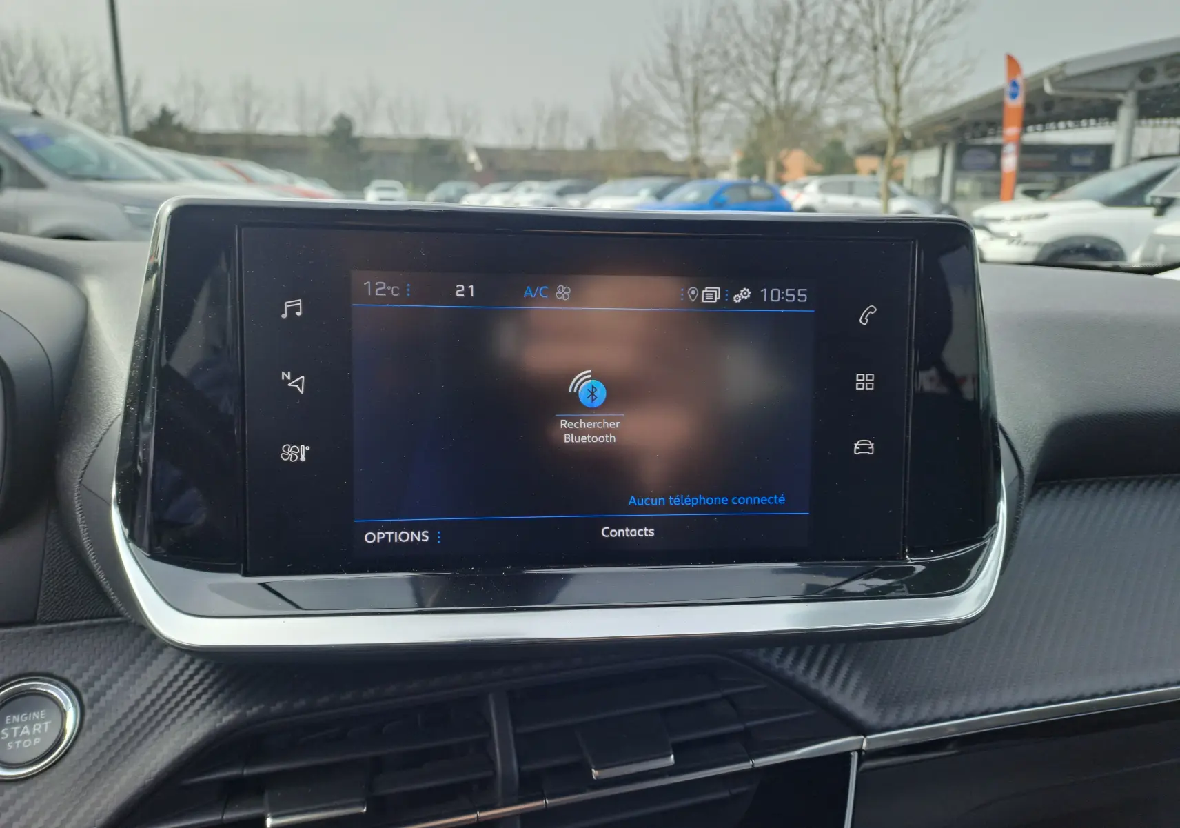 Écran tactile central du tableau de bord d'une Peugeot 2008 2020, affichant la recherche Bluetooth, intérieur noir.