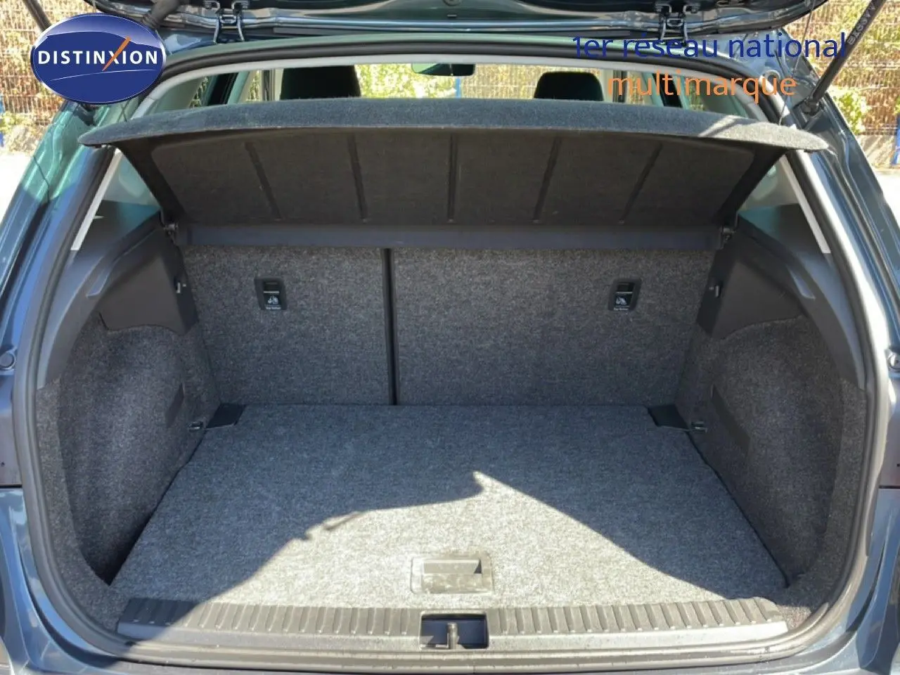 Coffre ouvert vu de l’arrière d’un SEAT Arona gris Magnetic Metal avec toit noir, montrant l’espace de chargement vide.