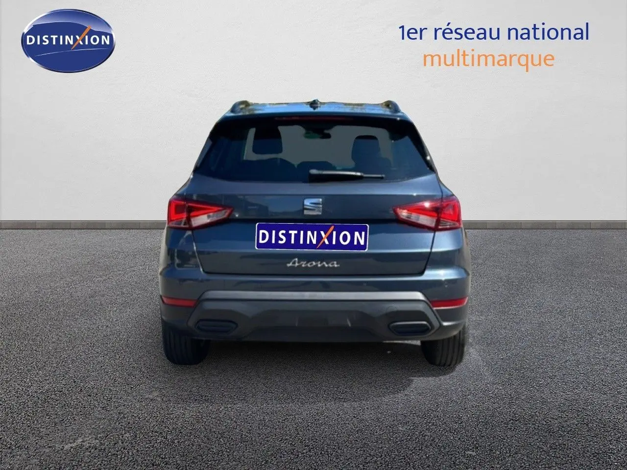 Vue arrière d’un SEAT Arona gris Magnetic Metal avec toit noir, mettant en valeur ses feux arrière et son logo central.
