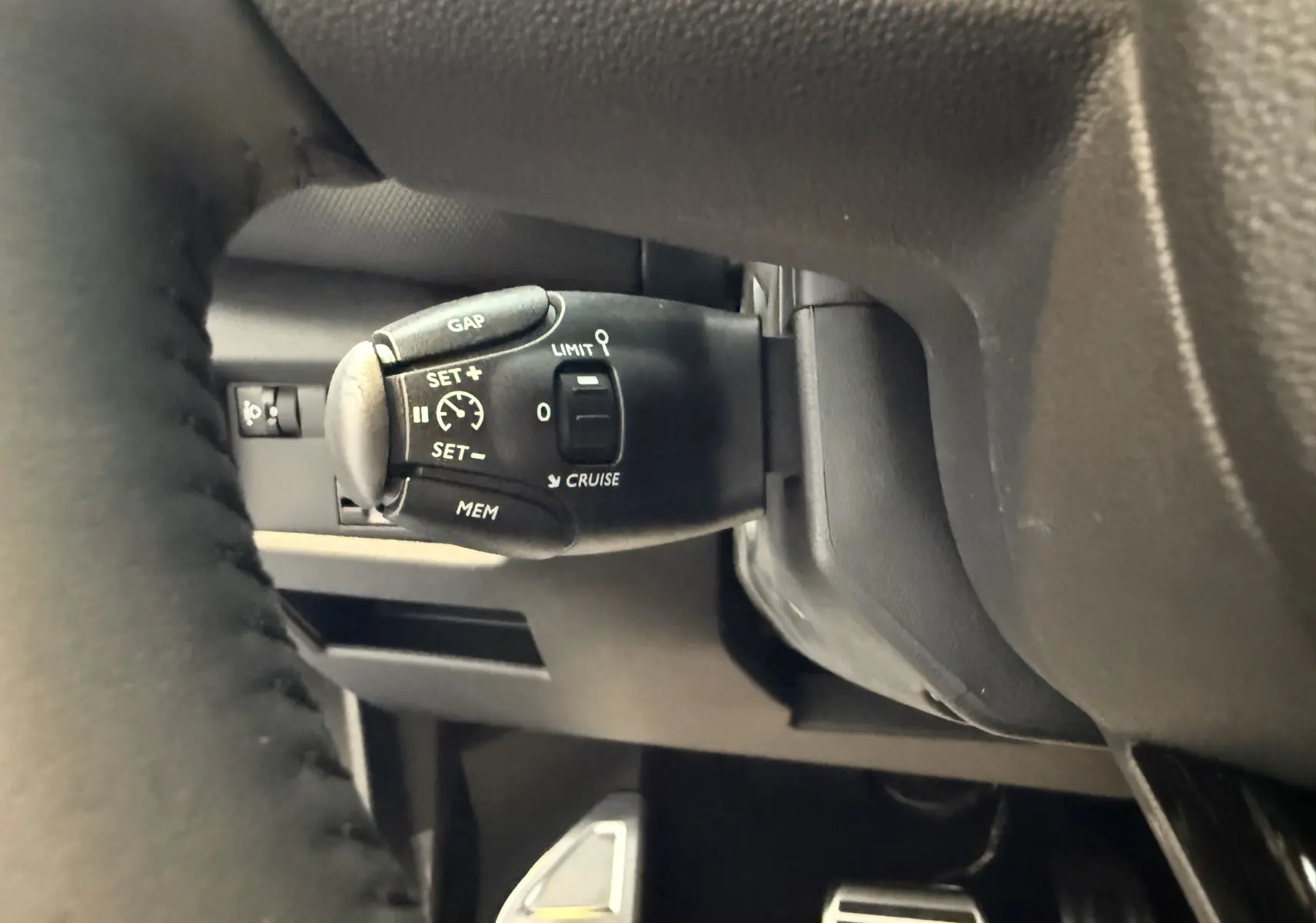 Gros plan sur la commande de régulateur de vitesse derrière le volant du Citroën C5 Aircross gris Artense 2022.