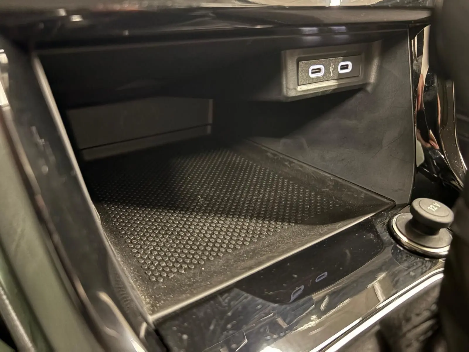 Espace de rangement avant avec prise USB double et prise 12V dans l'habitacle du Volkswagen T-Cross 2024 noir intense.