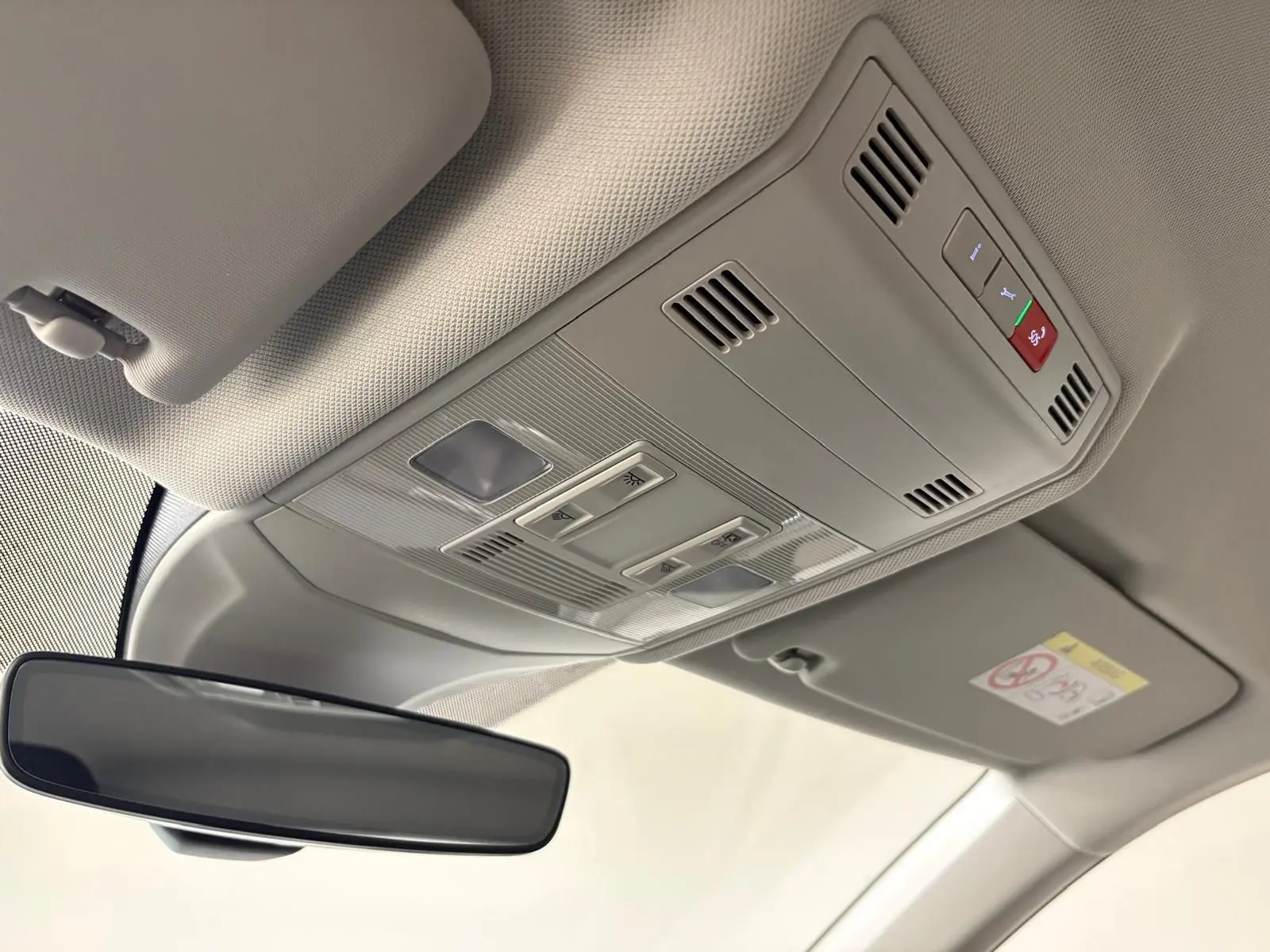 Plafonnier avec commandes d'éclairage et rétroviseur intérieur dans un Volkswagen T-Cross noir intense 2024.