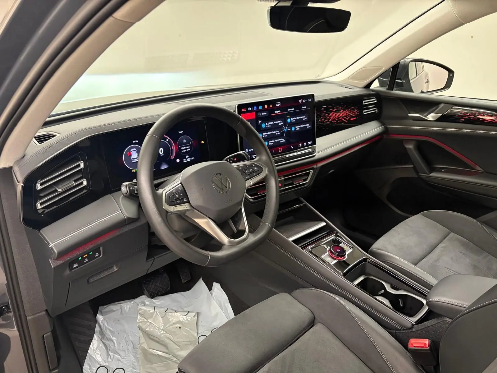 Vue intérieure côté conducteur du Volkswagen Tiguan 2.0 TDI 150 DSG7 Elegance, avec tableau de bord numérique et sellerie gris foncé.