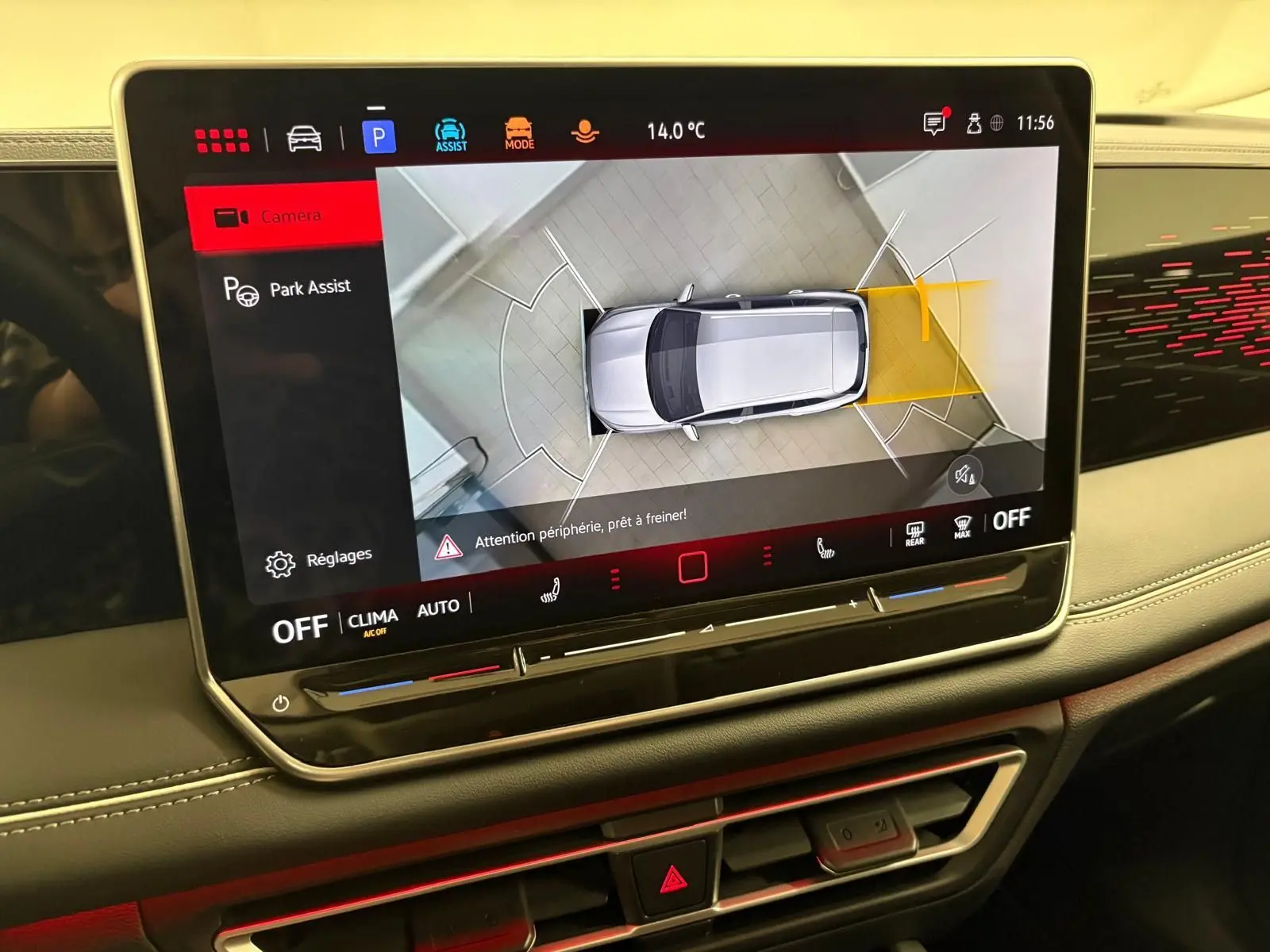 Écran central du Volkswagen Tiguan 2025 montrant l’aide au stationnement avec vue aérienne du véhicule gris dauphin.