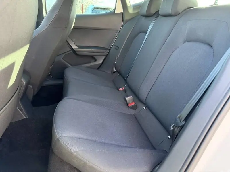 Vue intérieure du siège arrière côté droit de la SEAT IBIZA 2025, tissu noir avec ceintures de sécurité visibles.