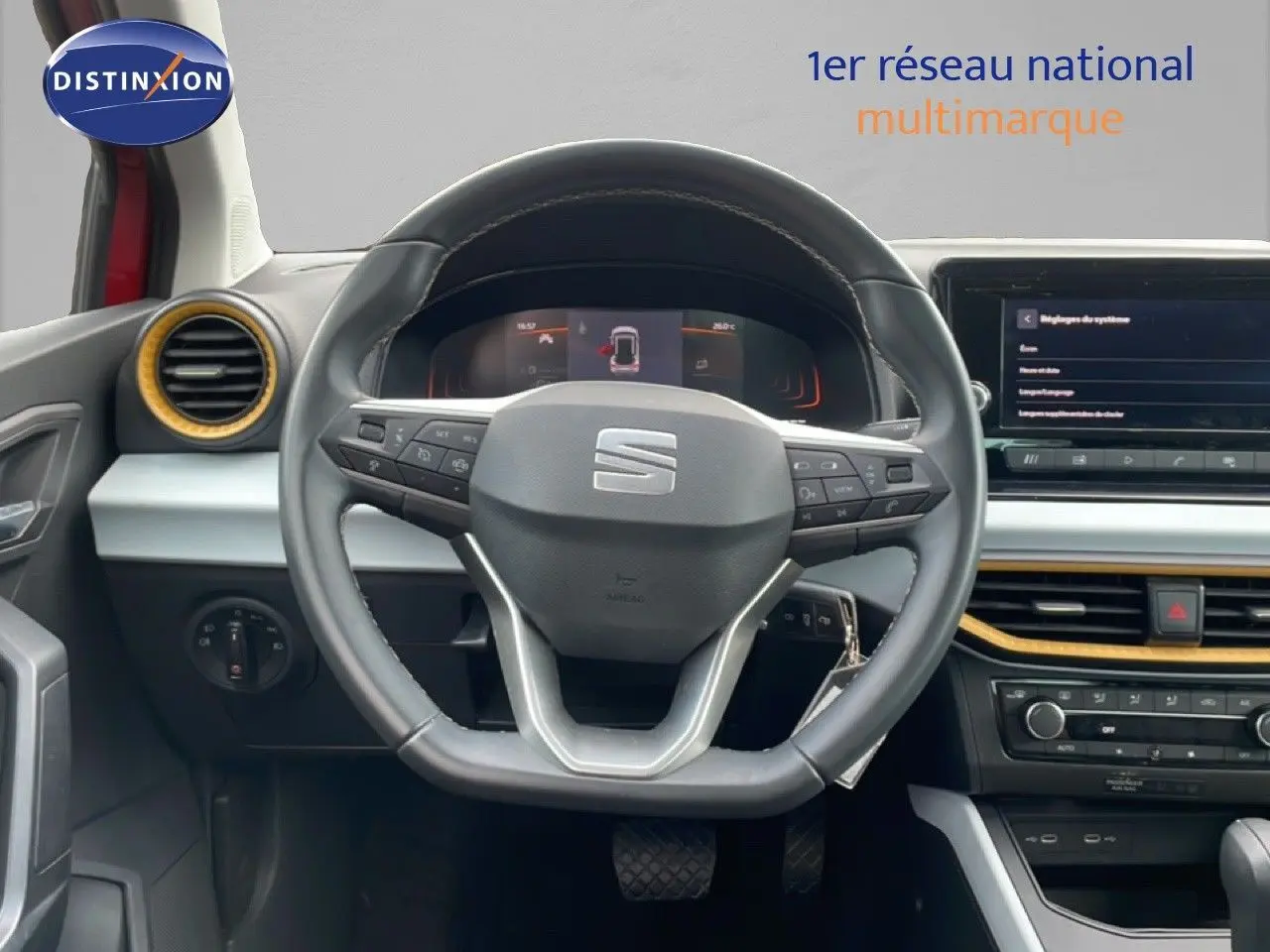 Vue intérieure centrée sur le volant cuir de la SEAT Arona 2025 avec tableau de bord et écran tactile.
