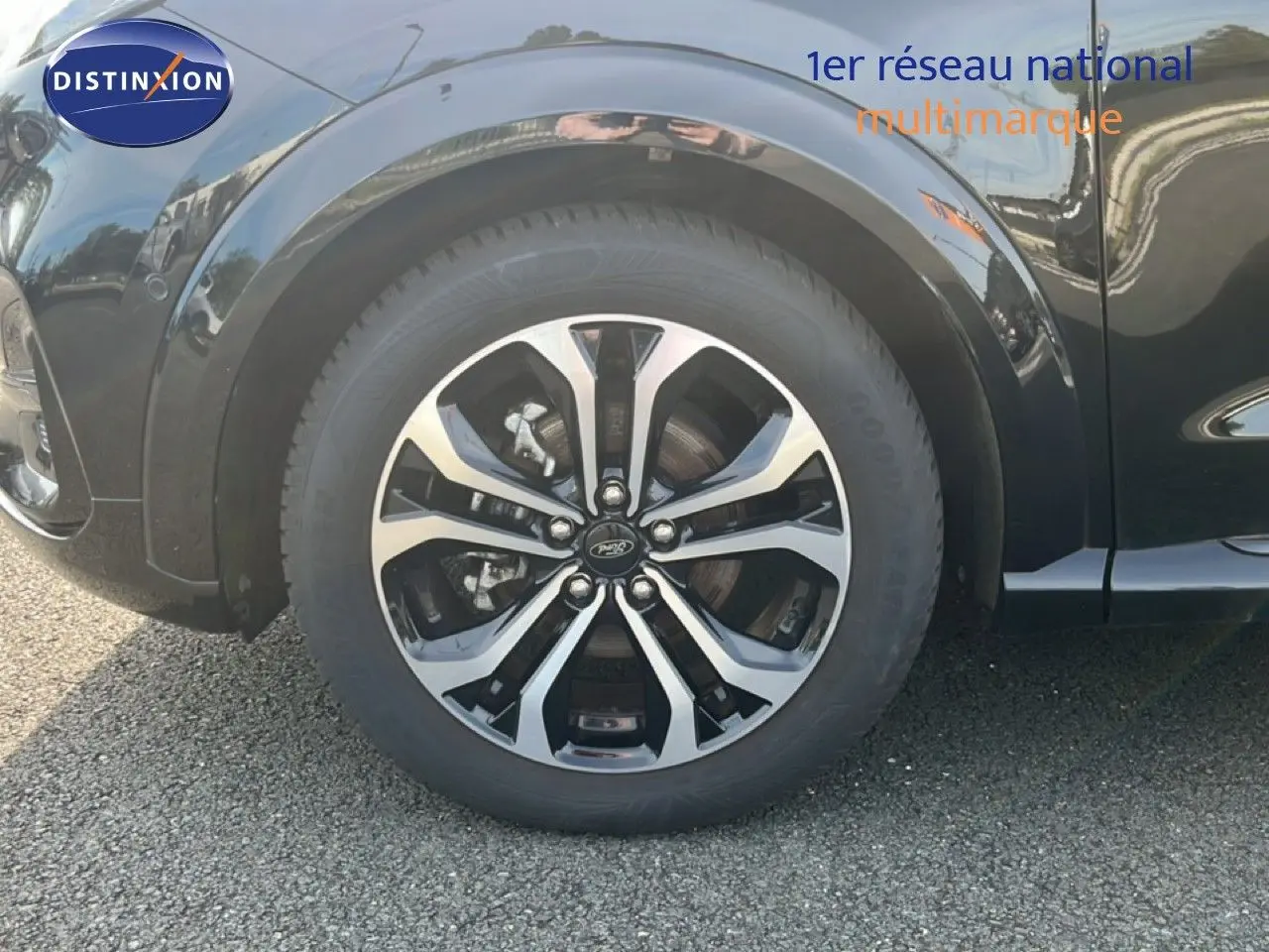 Gros plan sur la roue avant gauche d’un Ford Puma noir Agate Metal avec jante alliage bicolore.