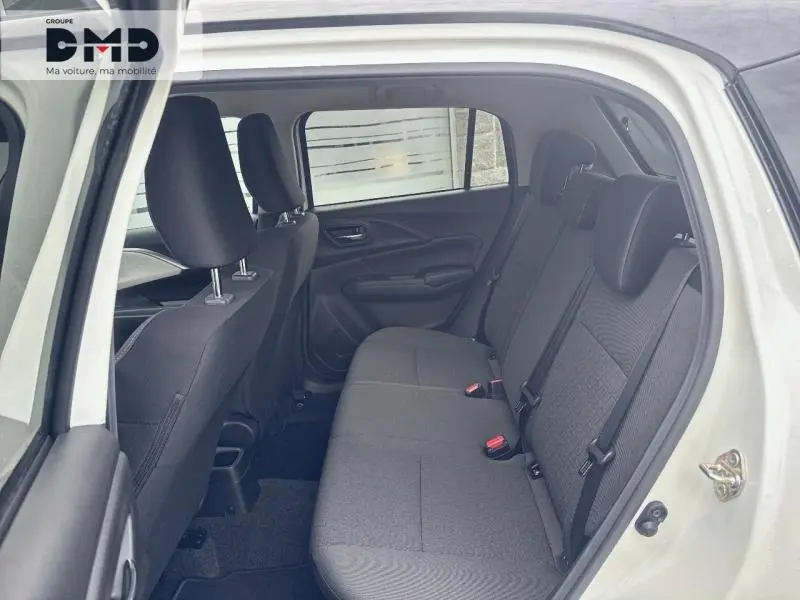 Vue latérale intérieure côté droit de la banquette arrière noire de la Suzuki Swift 1.2 Hybrid 2025 en blanc avec toit gris.
