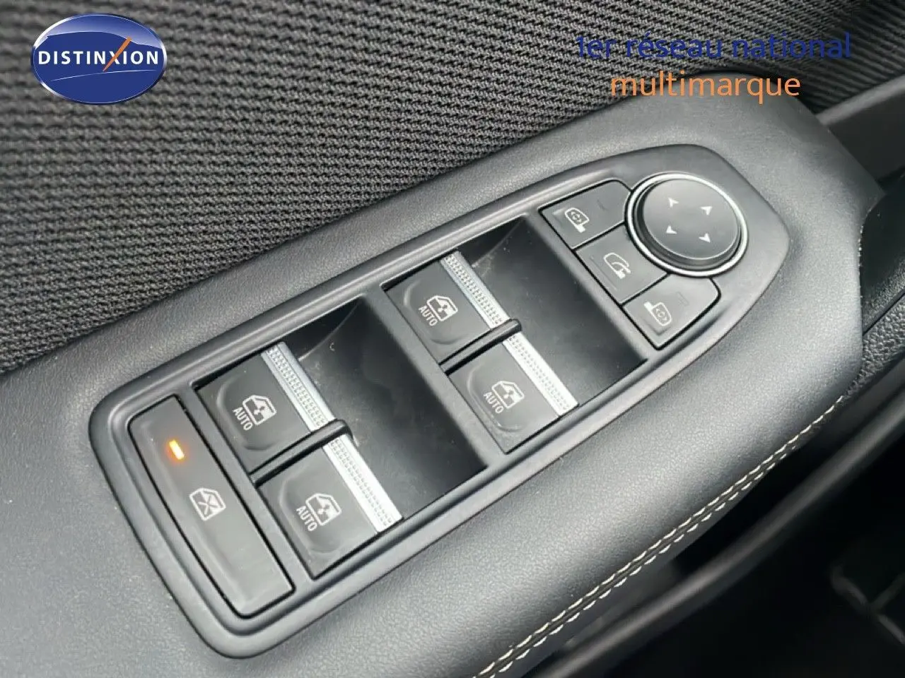 Gros plan sur les commandes de lève-vitres et rétroviseurs sur la porte côté conducteur du Renault Symbioz noir étoile métal.