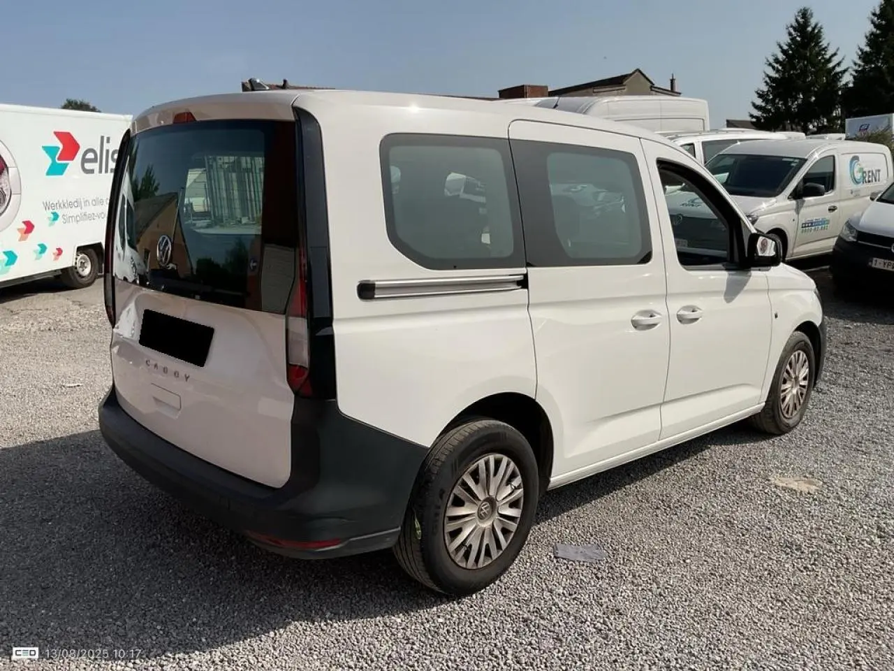 Vue 3/4 arrière droite d'un Volkswagen Caddy blanc Candy 2024 avec portes coulissantes et hayon vitré.