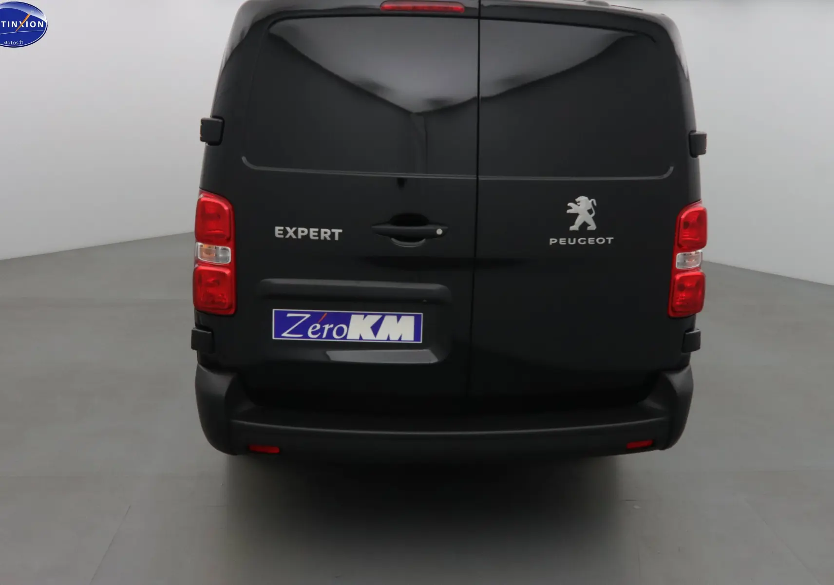 Vue arrière d'un Peugeot Expert Cabine Approfondie noir perle métal avec logo et plaque Zero KM visible.