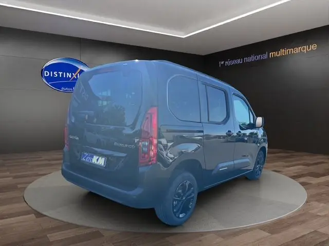 Vue 3/4 arrière droite d'un Citroën Berlingo N1 BlueHDi 130 noir avec jantes noires et hayon dans un showroom.