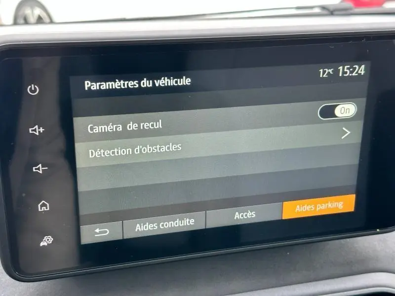 Écran tactile du tableau de bord du Dacia Jogger 1.6 hybrid noir, affichant les paramètres d'aide au parking.