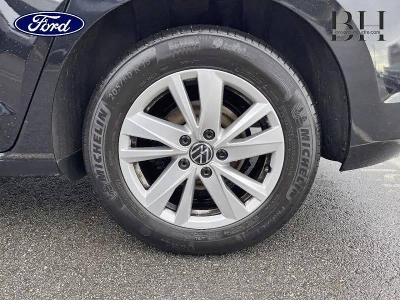 Gros plan sur la roue avant droite d'un Volkswagen Touran noir intense nacré avec jante alliage et pneu Michelin