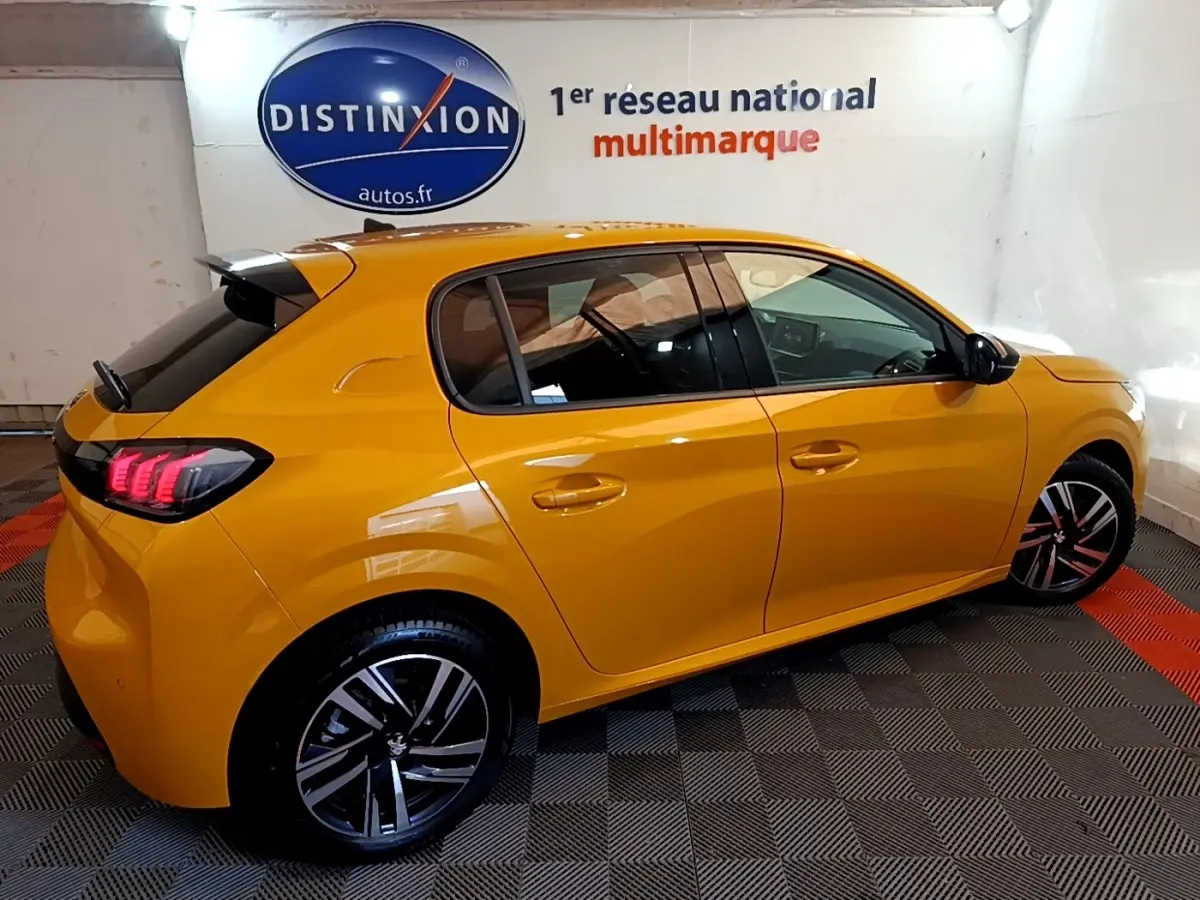 Peugeot 208 PureTech 100 S&S Allure Pack jaune vue de profil droit, feux arrière LED et jantes alliage visibles.
