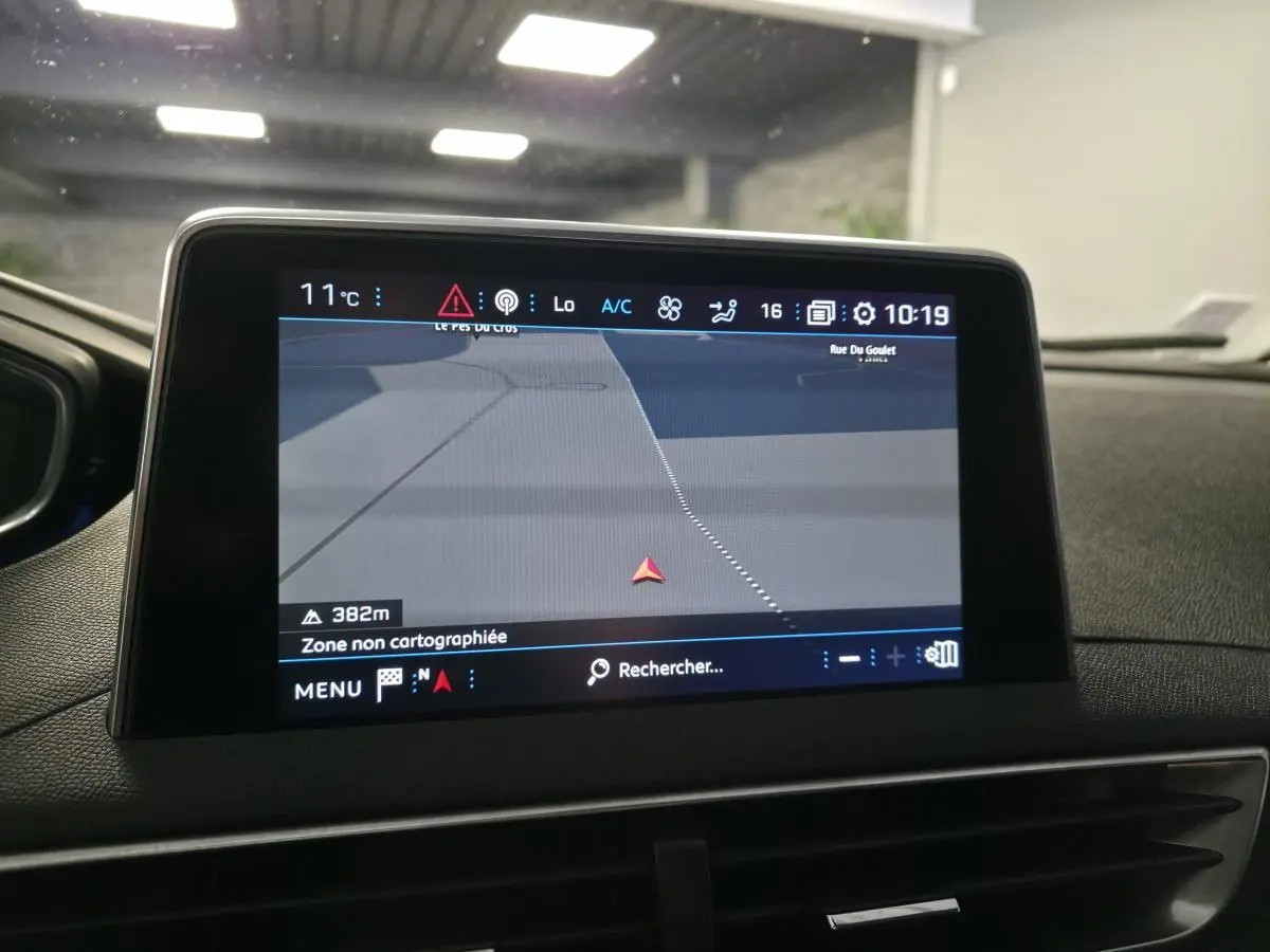 Écran tactile central du Peugeot 5008 bleu de 2019 affichant la navigation dans un intérieur sombre