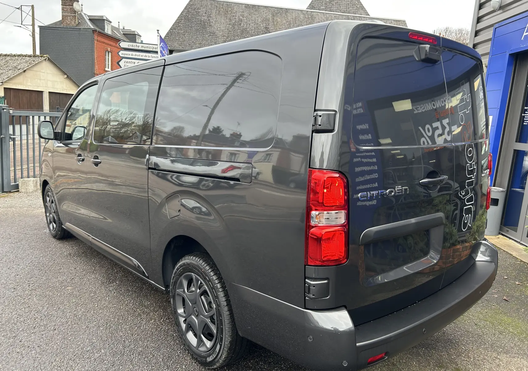 Vue 3/4 arrière droite du Citroën Jumpy cabine approfondie gris titane métallisé avec feux arrière rouges et jantes noires.