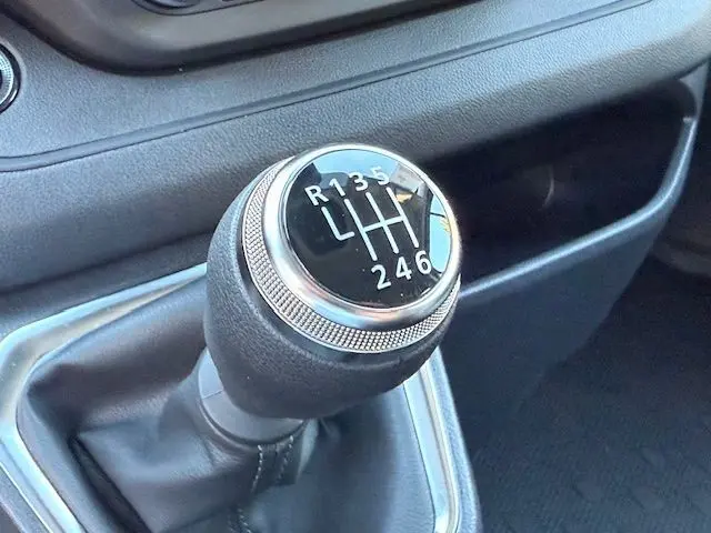 Le levier de vitesses manuel noir et chrome du Renault Trafic cabine approfondie 2025, avec marquages des six rapports visibles.