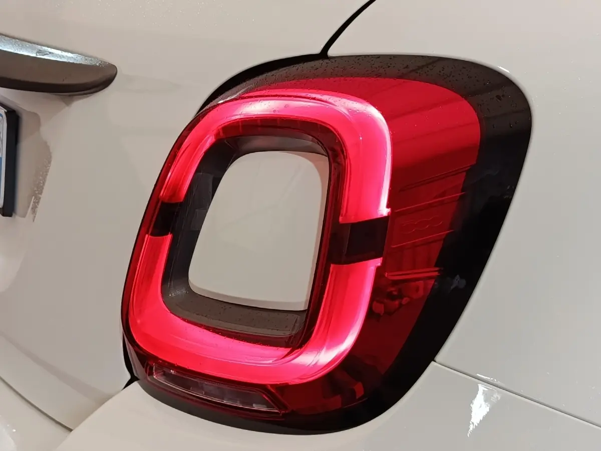 Gros plan sur le feu arrière droit rouge et noir d'une FIAT 500X noire, détails du logo 500 visibles.