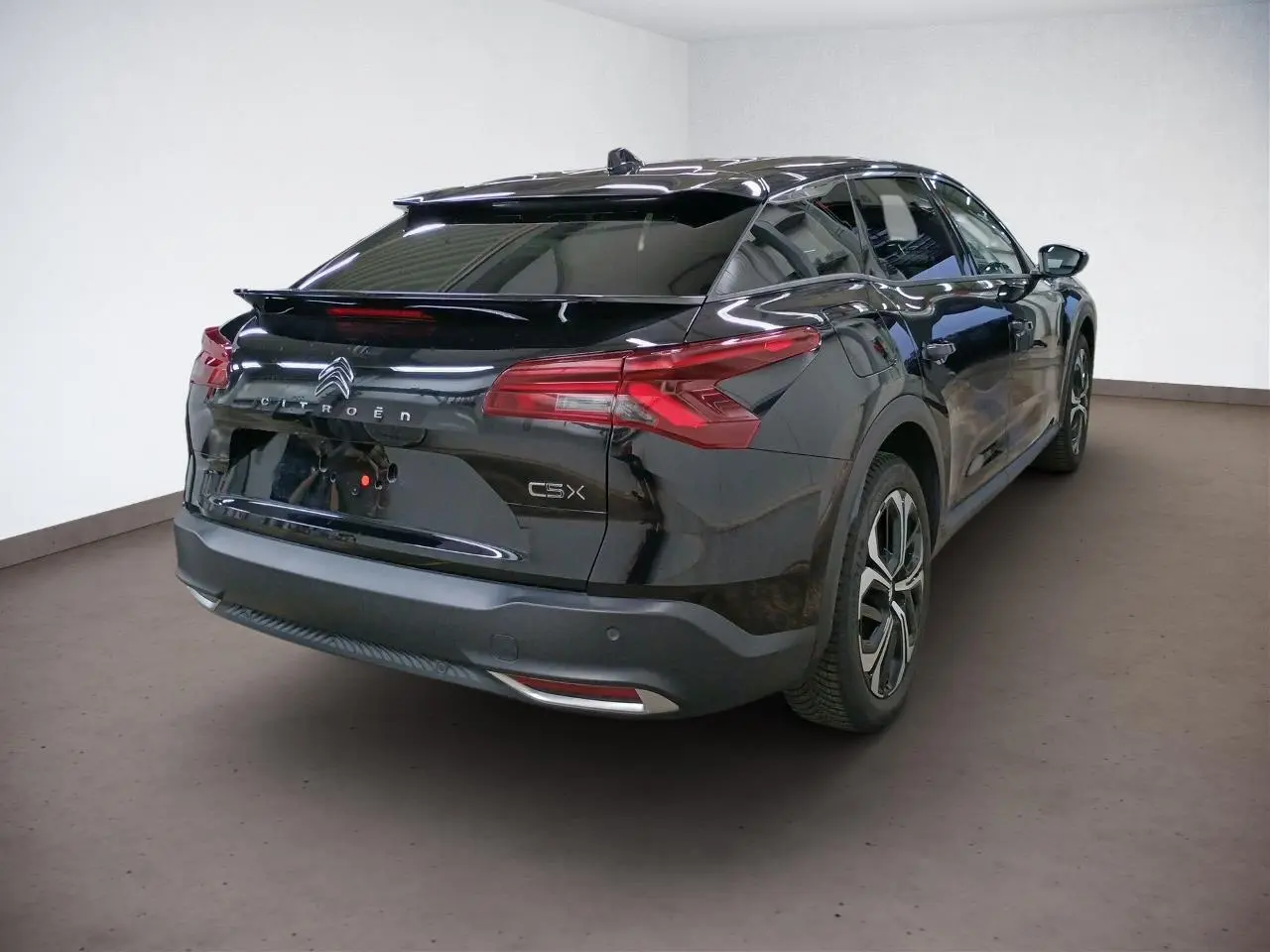 Vue intérieure avant du tableau de bord du Citroën C5 X 2024 avec écran GPS tactile 12 pouces et volant cuir noir.