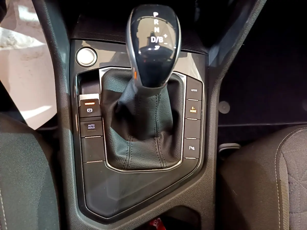 Gros plan sur la console centrale du Volkswagen Tiguan 1.4 eHybrid 2021 avec levier de vitesse automatique et boutons de contrôle.