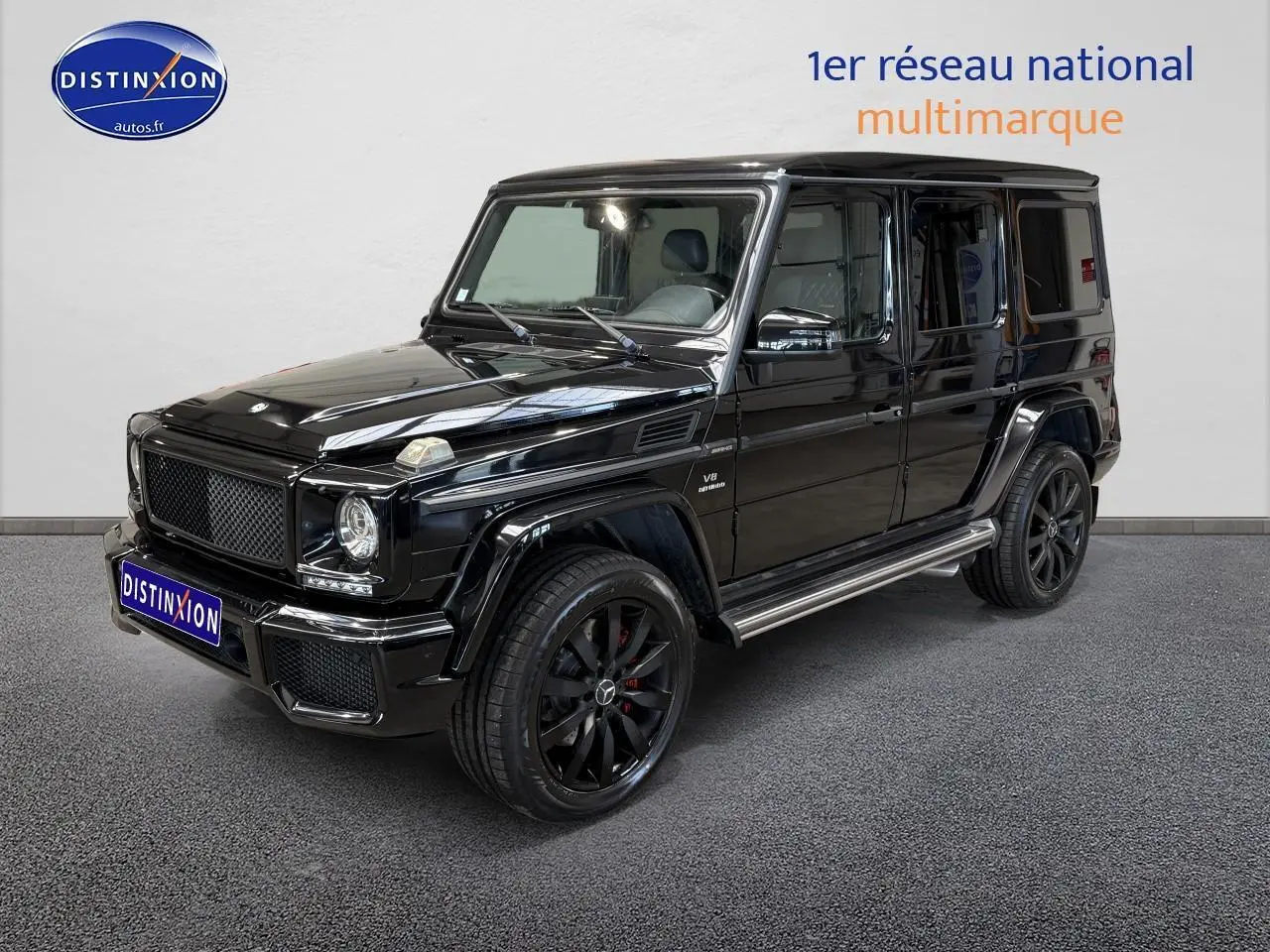 Mercedes Classe G 5.5 63 AMG noir en 3/4 avant droit avec jantes noires et calandre distinctive.