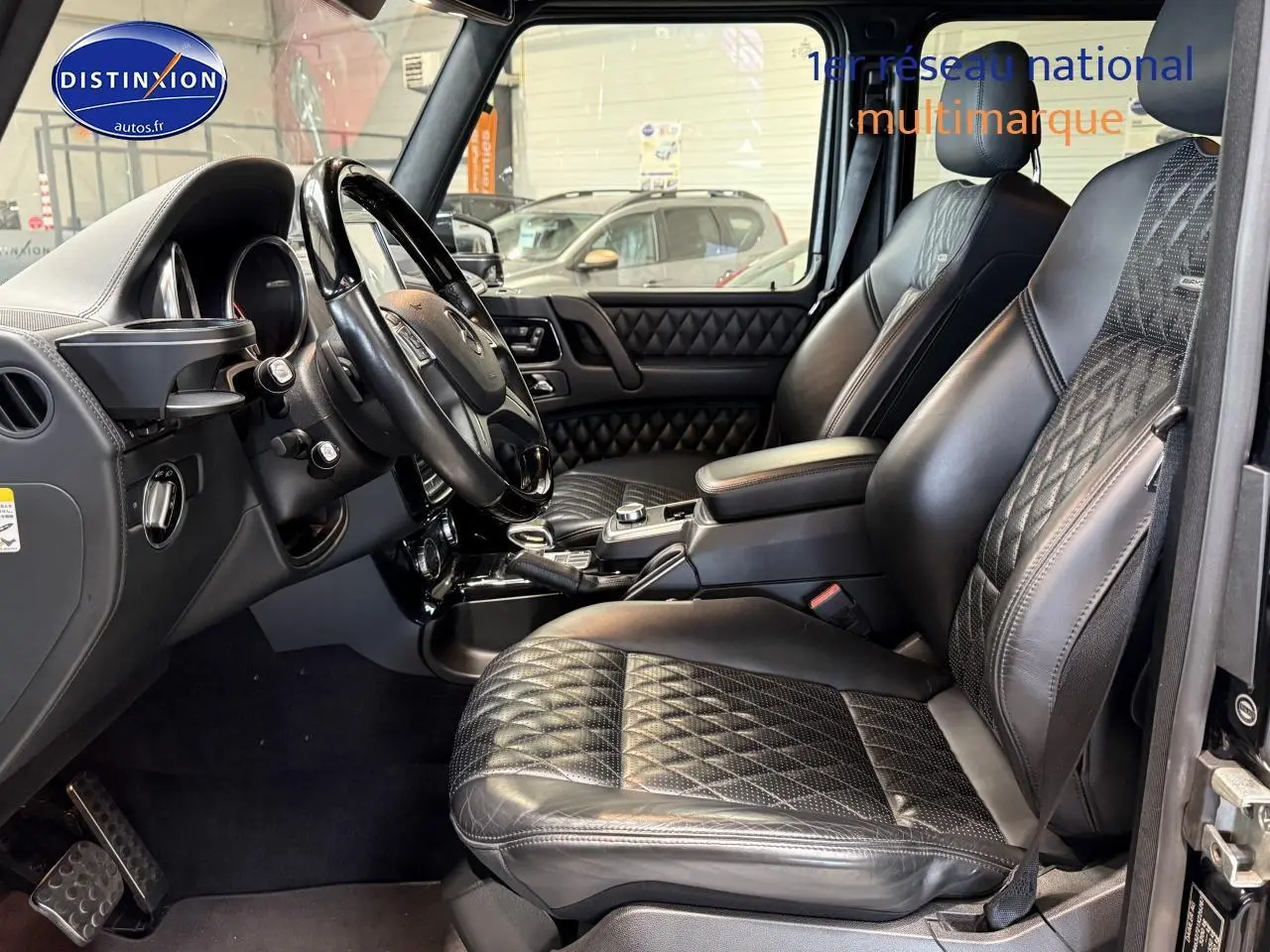 Intérieur noir du Mercedes Classe G 5.5 63 AMG 2014, vue côté conducteur sur sièges cuir sport et tableau de bord.