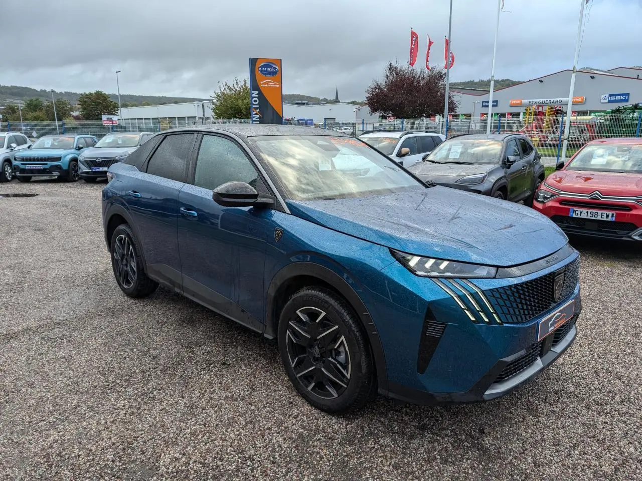 Peugeot 3008 GT bleu métallisé vue 3/4 avant droit, avec calandre noire et feux LED griffés 3D.