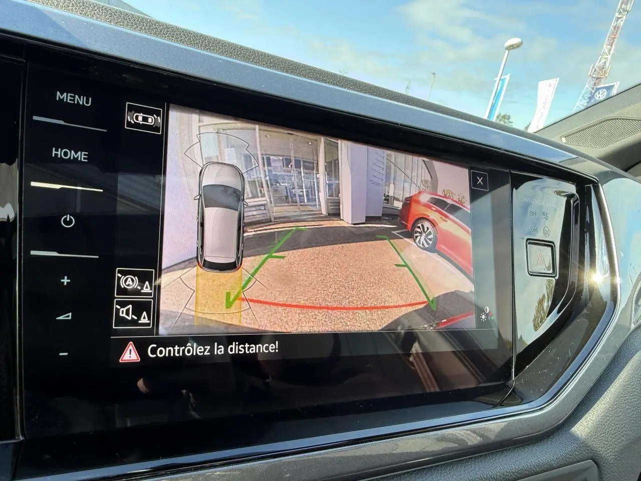 Écran tactile intérieur montrant la caméra de recul avec vue arrière et assistance au stationnement du Volkswagen Polo noir intense nacré.