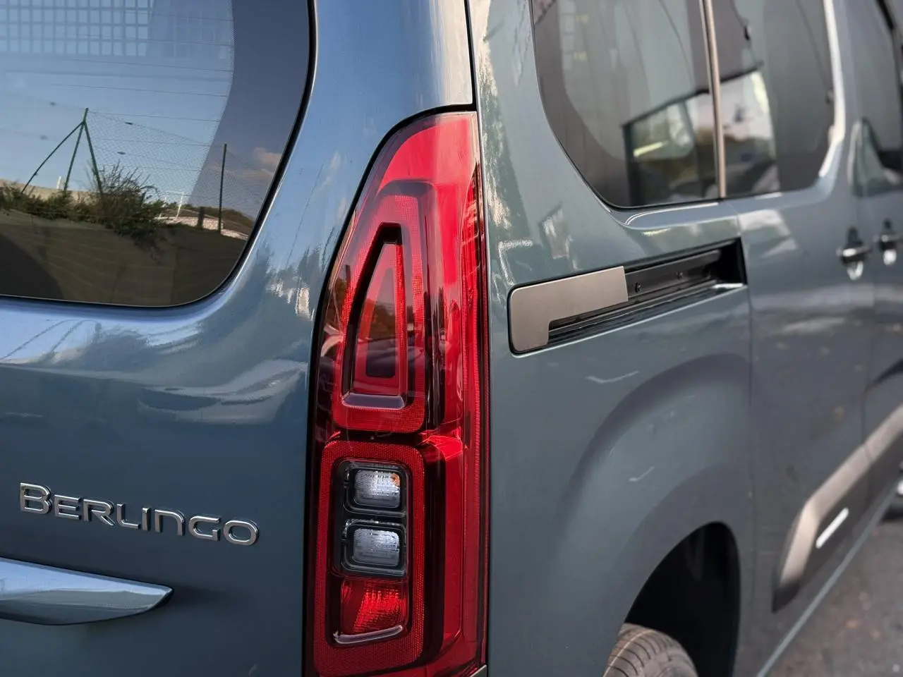 Gros plan sur le feu arrière droit et la partie latérale bleue métallisée du Citroën Berlingo Multispace 2025.