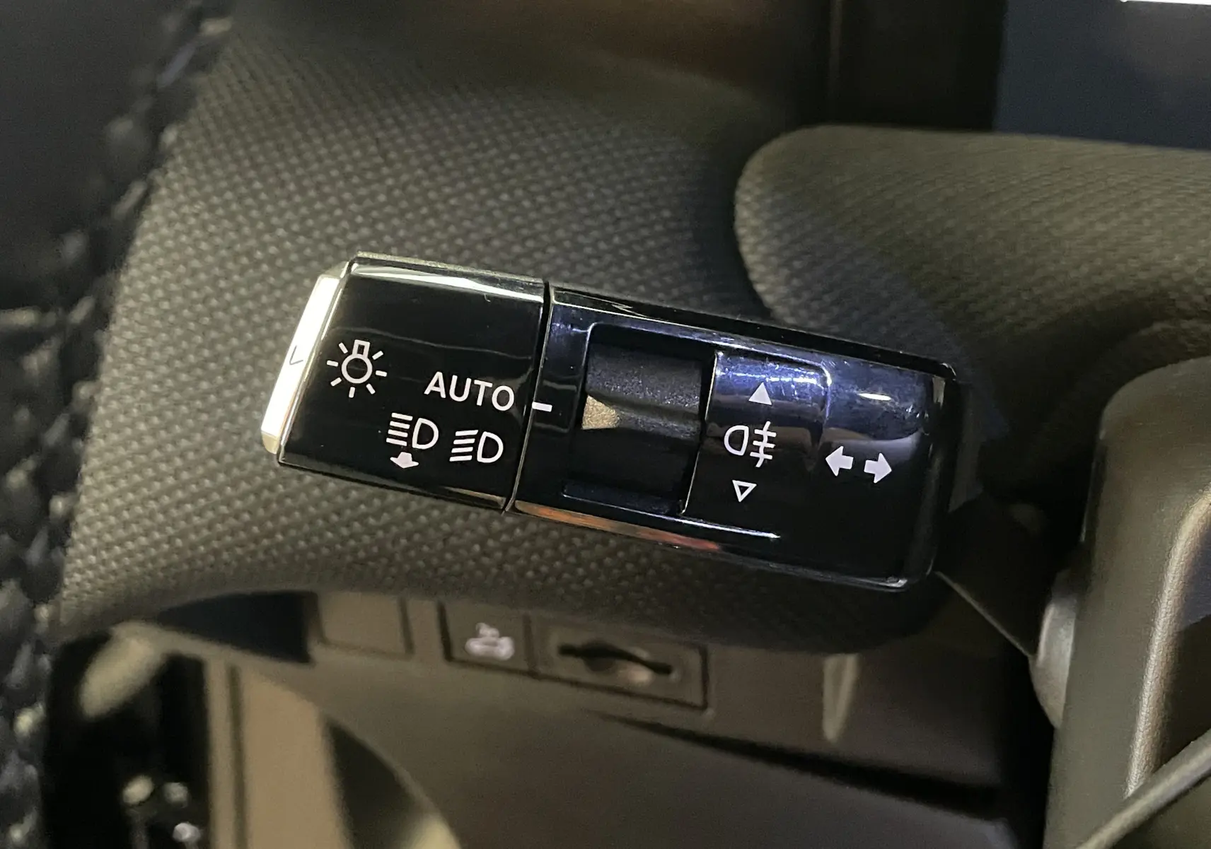 Gros plan sur la commande des feux automatique et clignotants dans l'habitacle du Citroën C5 Aircross hybride 2026.