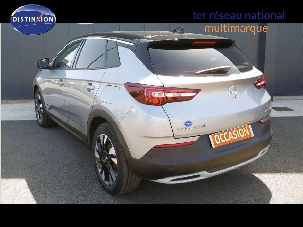 Opel Grandland X gris Himalaya vu en 3/4 arrière droit avec toit noir et feux arrière LED allumés