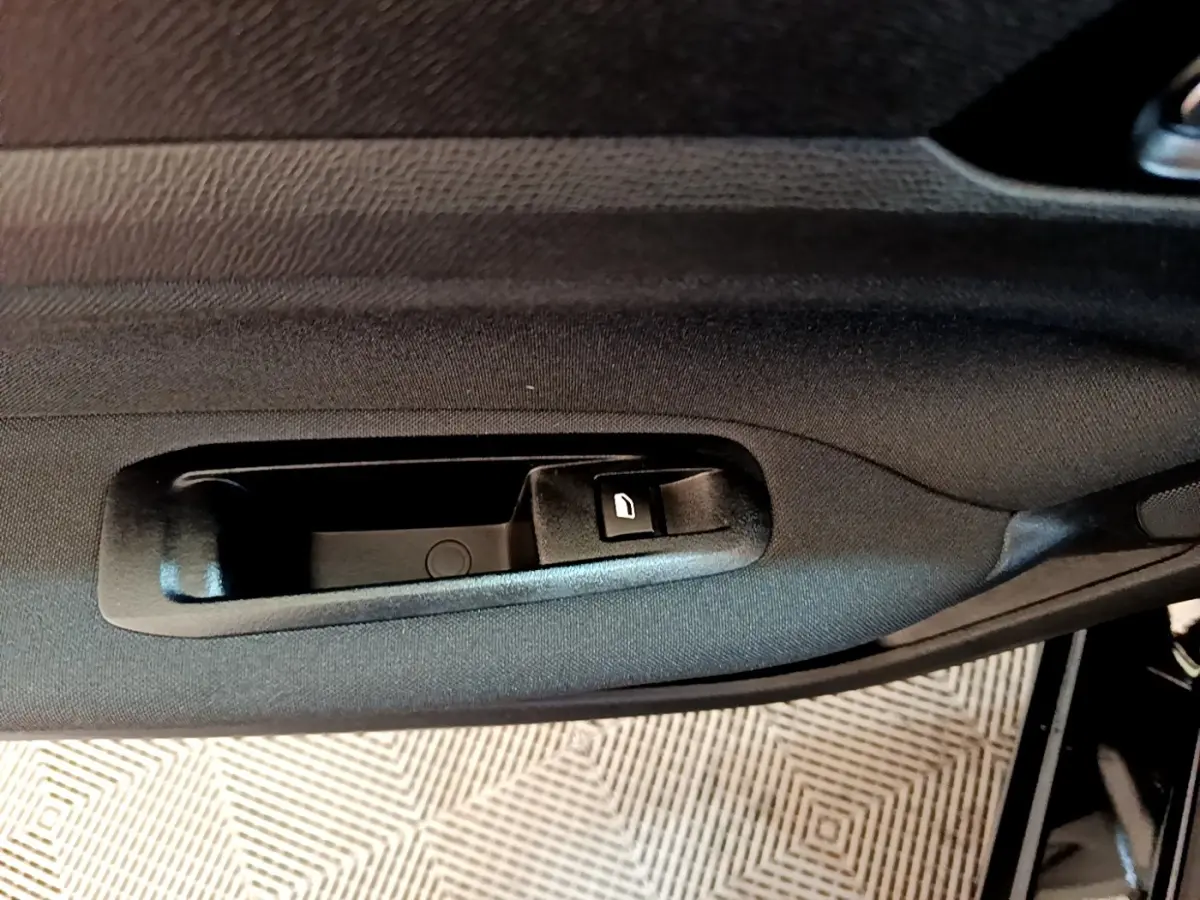 Poignée intérieure côté gauche de porte noire de Peugeot 308 Active Business 2020, avec bouton de verrouillage.