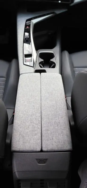 Vue plongeante sur la console centrale grise et les sièges noirs du Peugeot 3008 Hybrid 136 e-DCS6 Allure 2025.