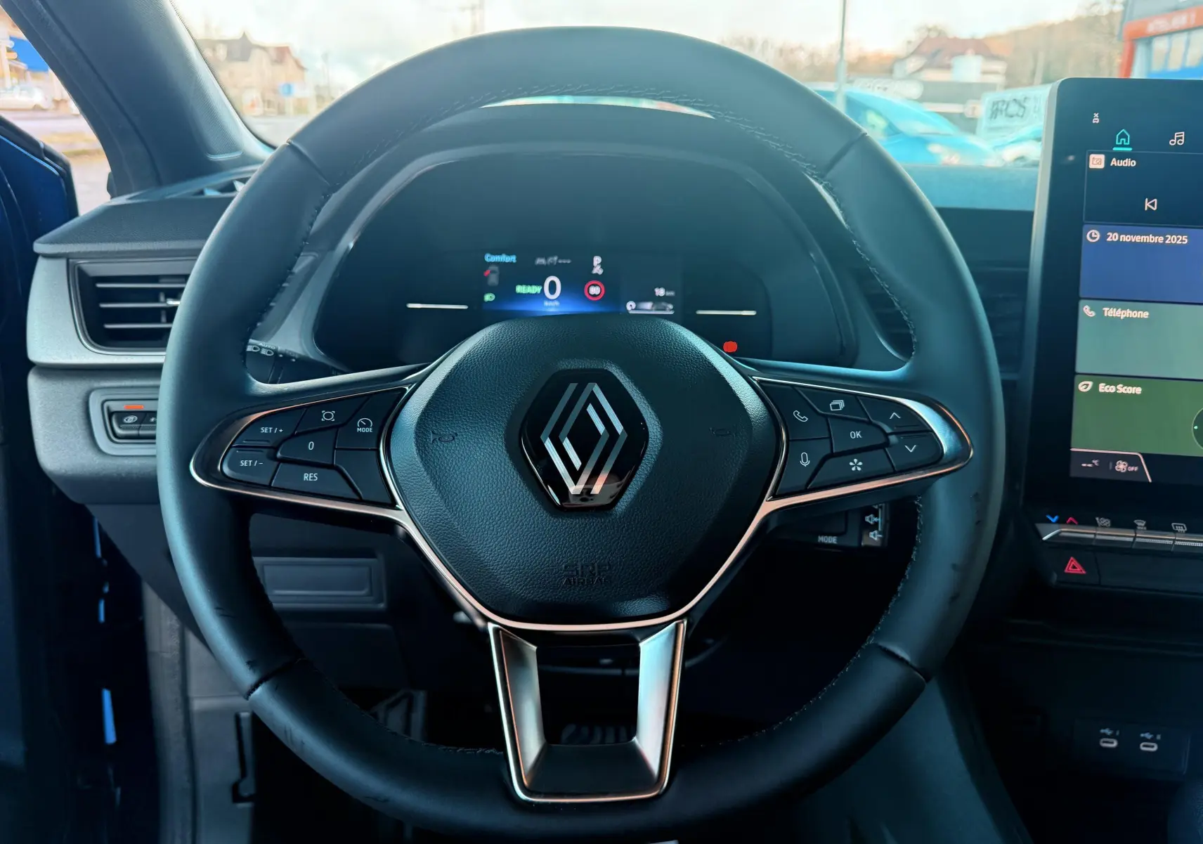 Vue rapprochée du volant noir du Renault Captur E-Tech 2025 avec commandes intégrées et tableau de bord digital.