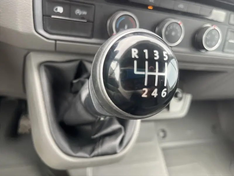 Le levier de vitesses manuel noir en gros plan dans l'habitacle du Volkswagen Crafter Fourgon blanc de 2019.