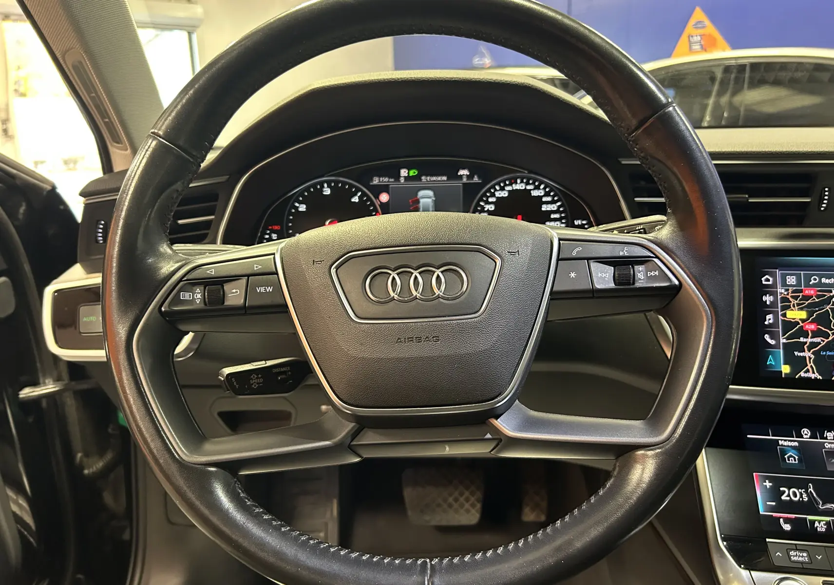 Volant en cuir noir avec commandes intégrées, tableau de bord et écran central d'une Audi A6 Avant 40 TDI 2019.