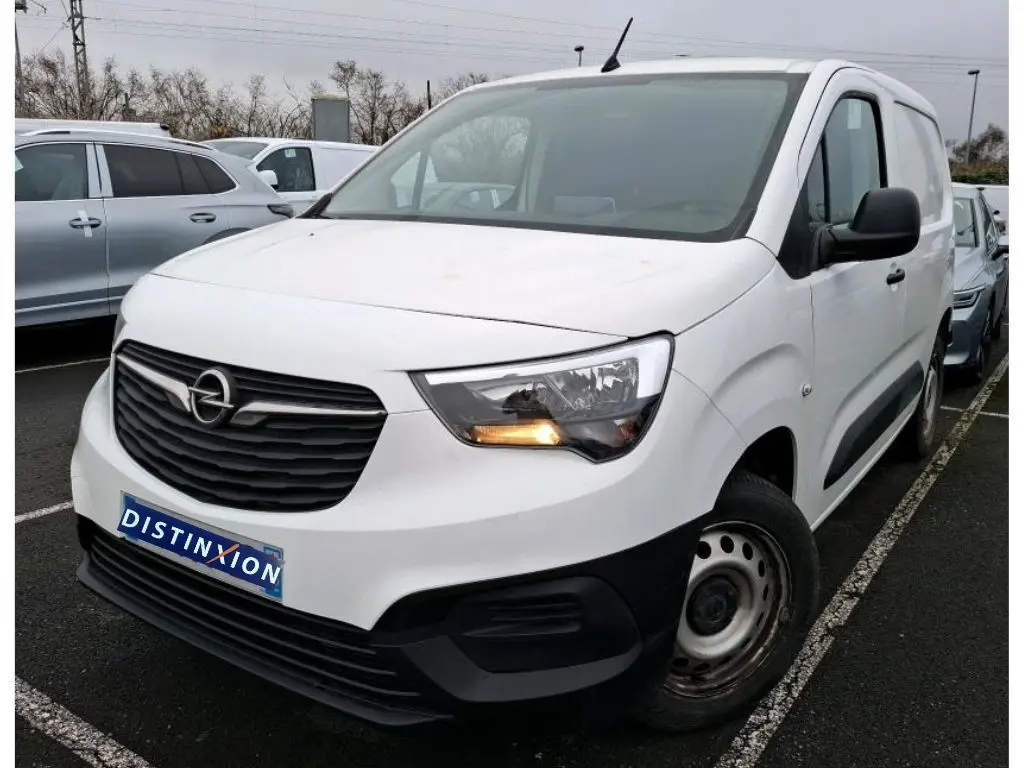 Vue 3/4 avant droit d'un Opel Combo Cargo blanc 2022 avec calandre noire et clignotant avant allumé.