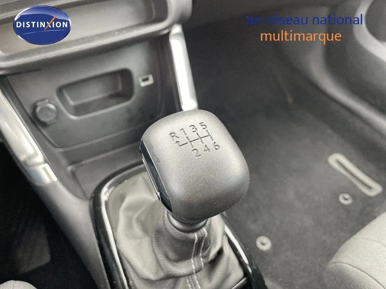 Le levier de vitesses manuel 6 rapports en gros plan dans l'habitacle d'une Citroën C3 Aircross blanc polaire.