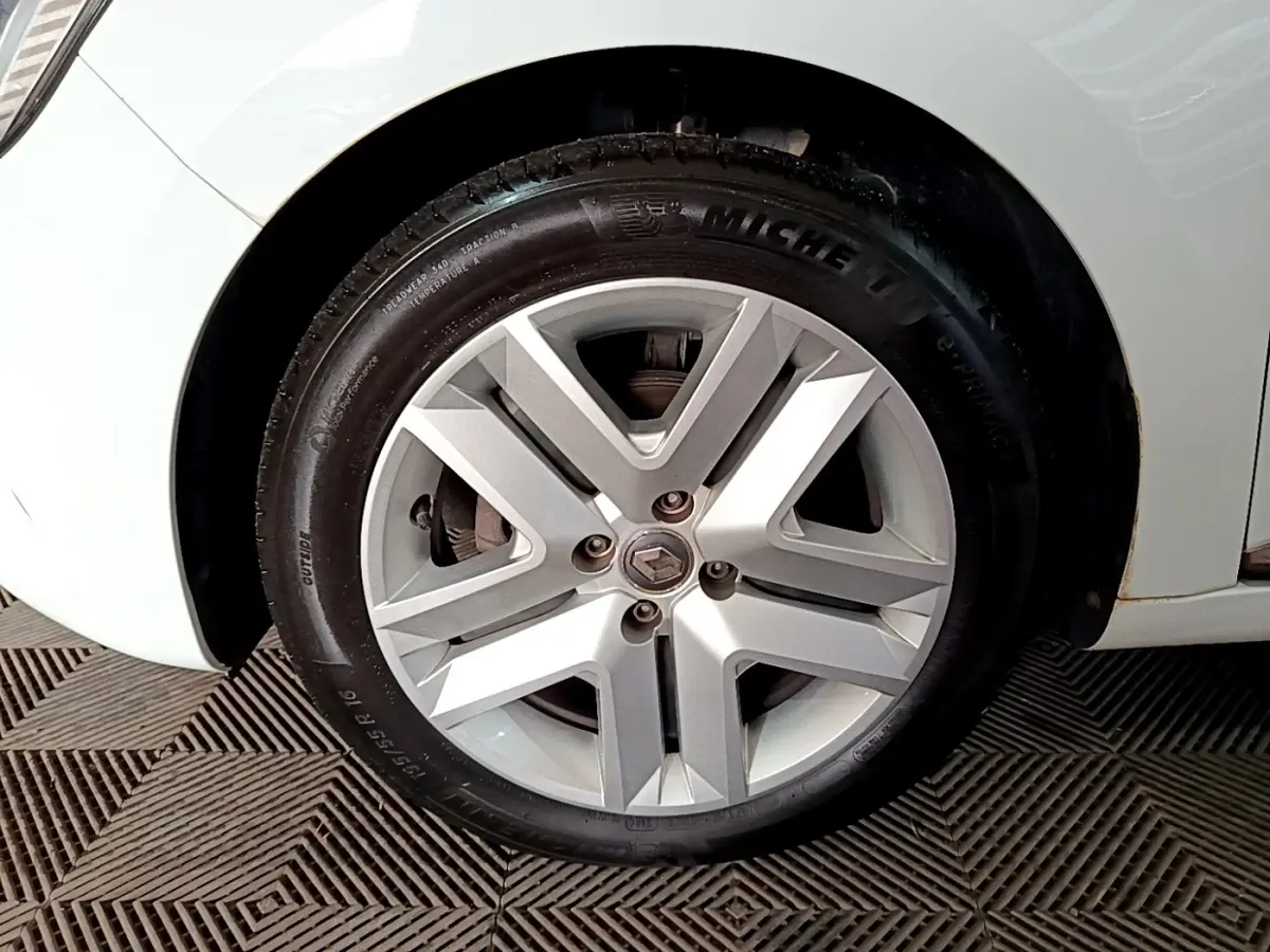 Gros plan sur la roue avant droite blanche d’une Renault Clio Business 2021 avec jante alliage et logo Renault.