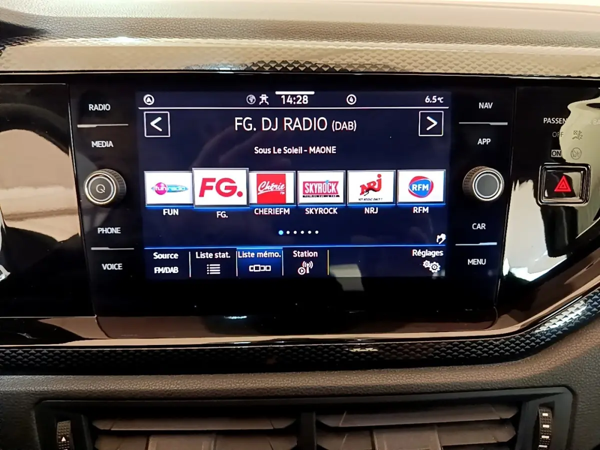 Écran tactile central du tableau de bord du Volkswagen Taigo noir, affichant les stations radio numériques.